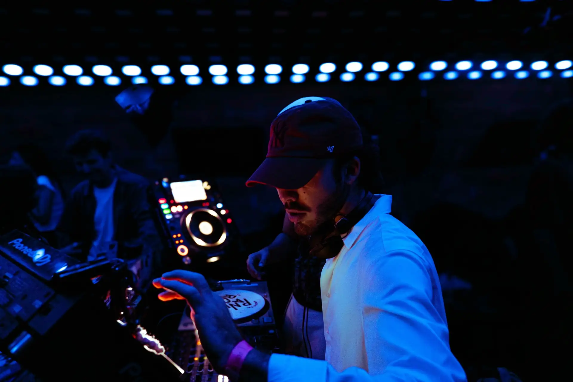 DJ under blue light at Panic Room